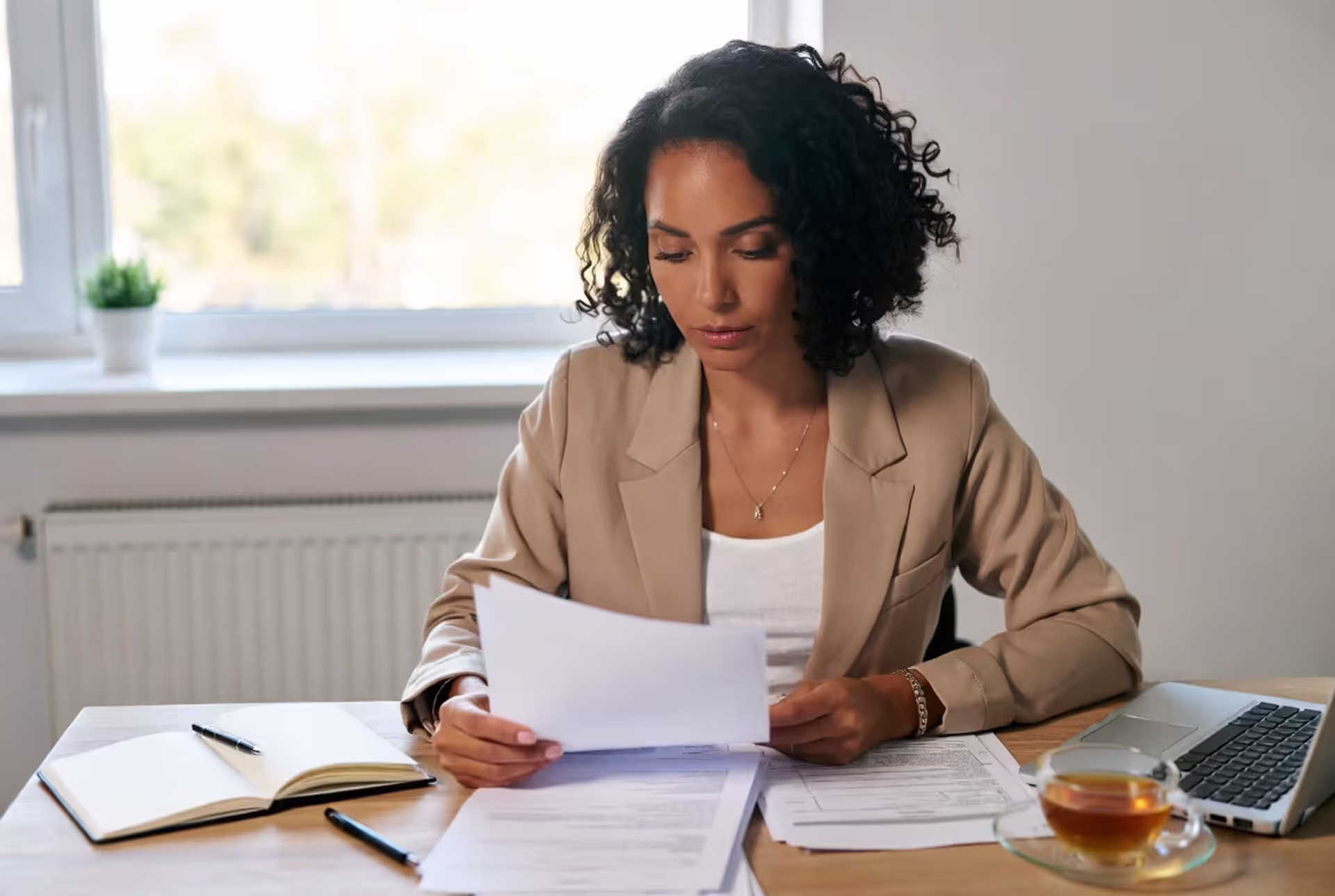 Woman reviewing legal documents at a desk for a domestic violence restraining order